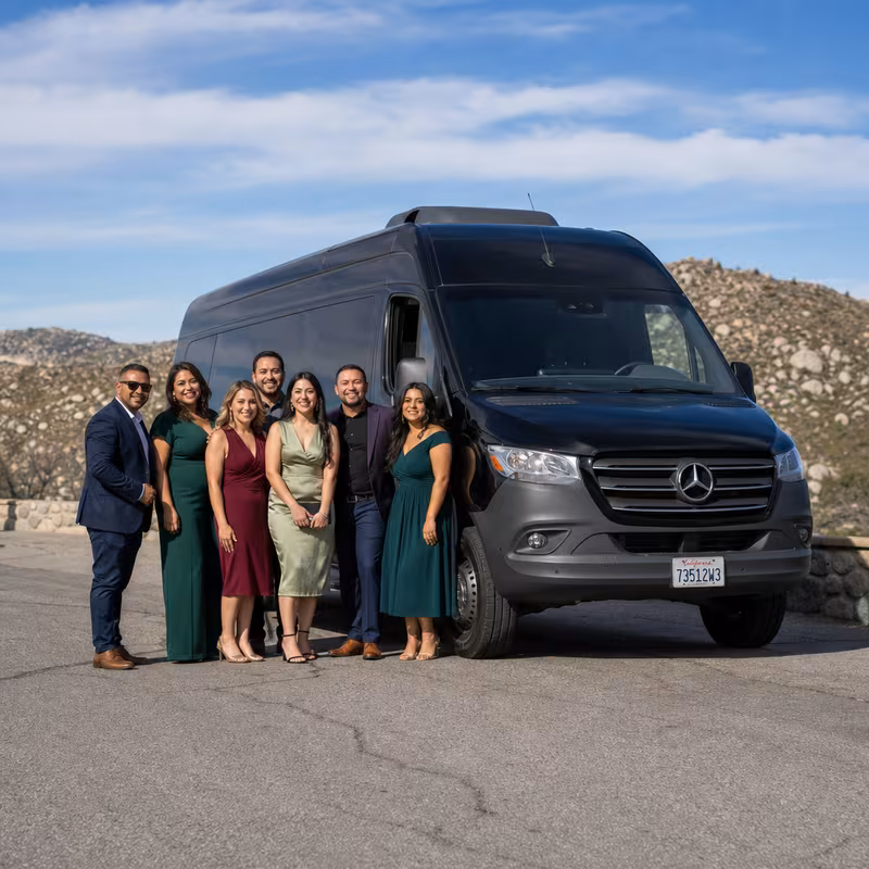 Group beside a Mercedes Sprinter limo from the Fresno fleet