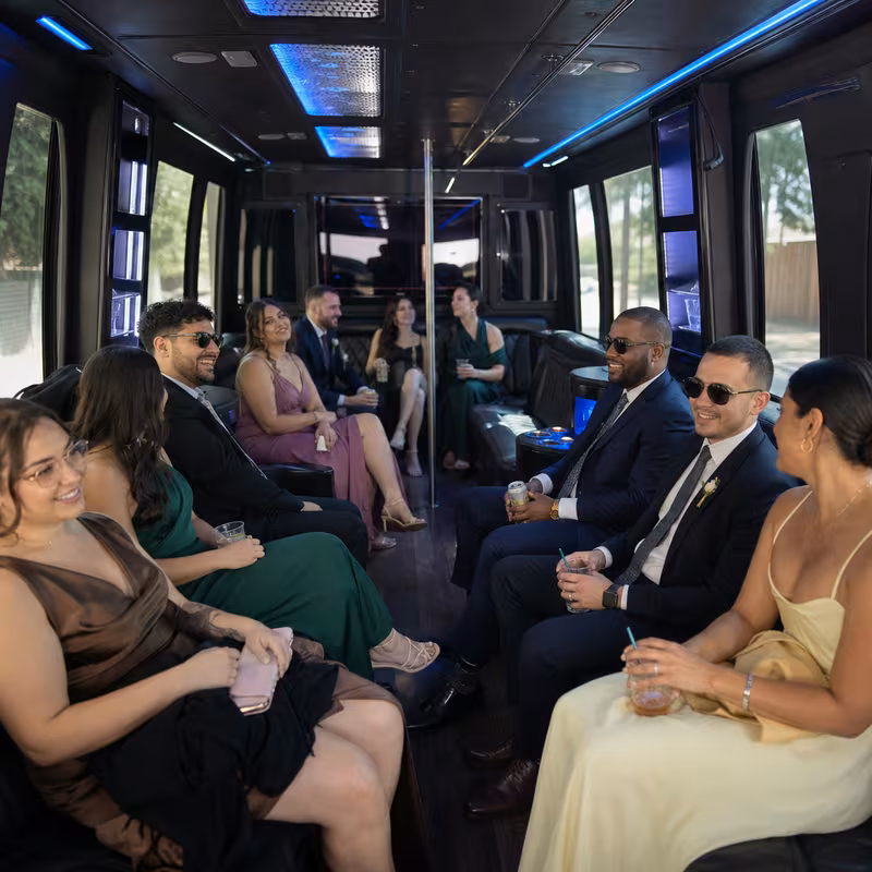 Wedding guests seated inside a Fresno party bus