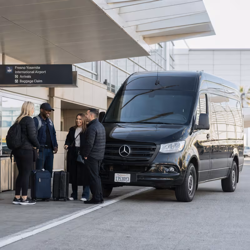 Group boarding a white charter bus for Airport Transportation transportation in Fresno