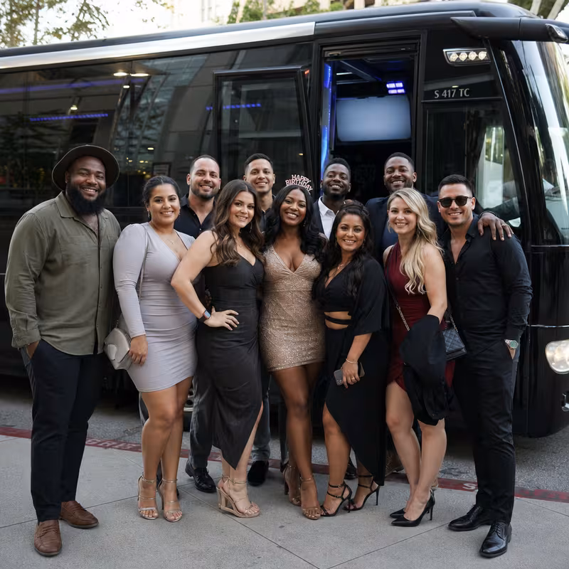 Group boarding a white charter bus for Birthday Transportation transportation in Fresno