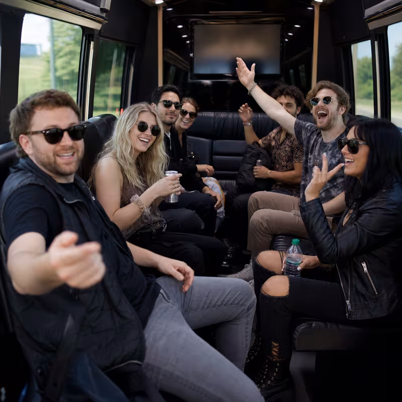 Group boarding a white charter bus for Concert Transportation transportation in Fresno
