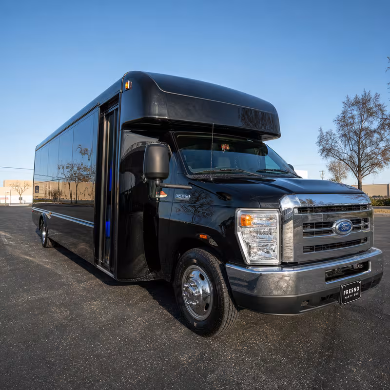 Party bus interior with wraparound leather seating and LED lighting in Fresno