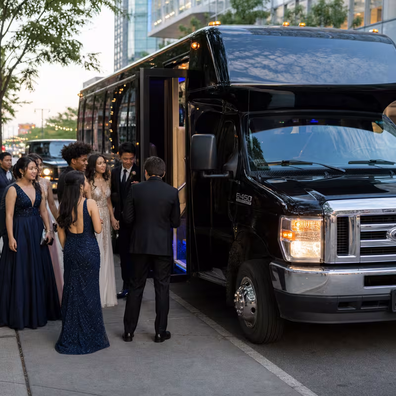 Passengers loading luggage while boarding an Fresno group shuttle