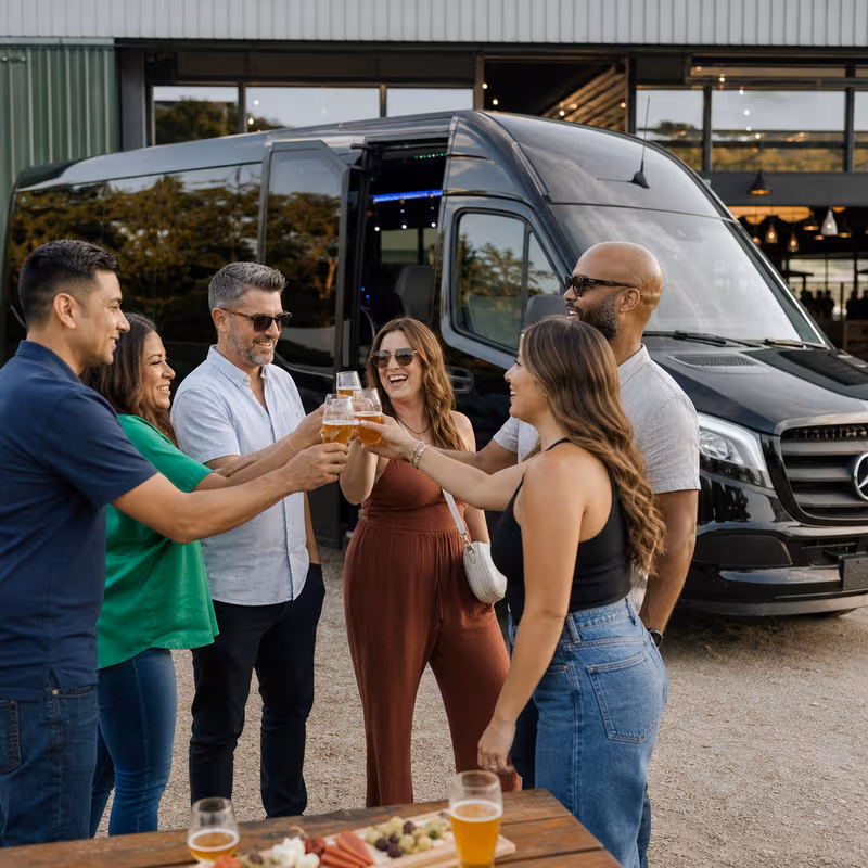 Passengers loading luggage while boarding an Fresno group shuttle